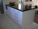 Peninsula unit with granite top, underbench microwave.