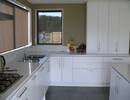 white kitchen with stone bench